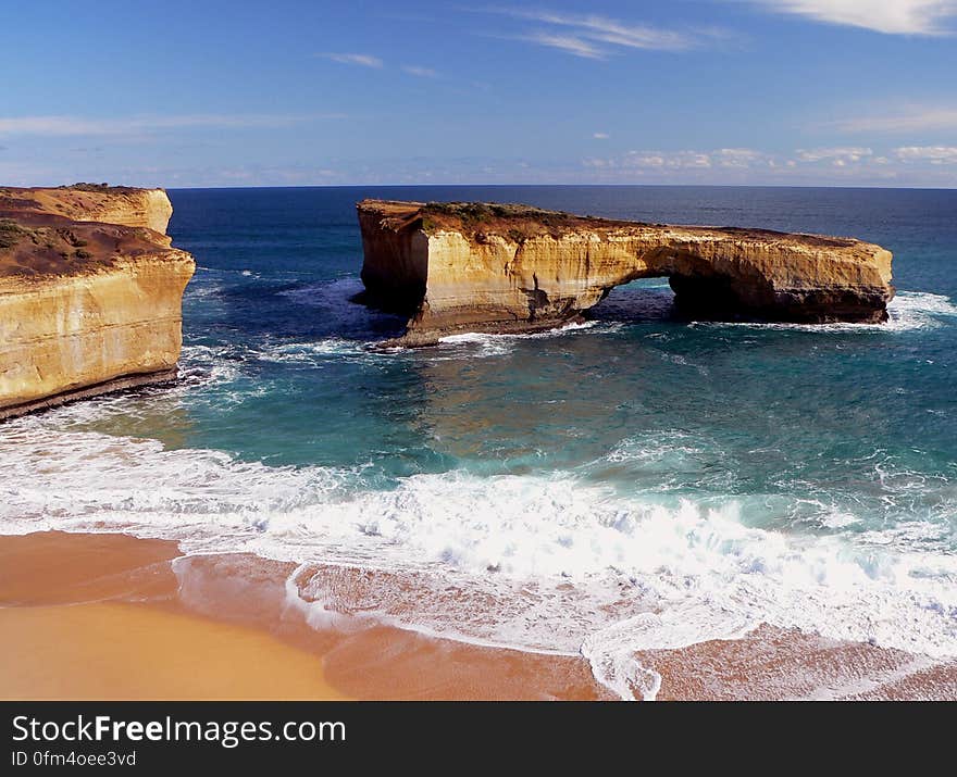 London Arch &#x28;formerly London Bridge&#x29; is an offshore natural arch formation in the Port Campbell National Park, Australia. The arch is a significant tourist attraction along the Great Ocean Road near Port Campbell in Victoria. This stack was formed by a gradual process of erosion, and until 1990 formed a complete double-span natural bridge. The span closer to the shoreline collapsed unexpectedly on 15 January 1990,[1] leaving two tourists stranded on the outer span before being rescued by helicopter. No one was injured in the event. Prior to the collapse, the arch was known as London Bridge because of its similarity to its namesake. London Arch &#x28;formerly London Bridge&#x29; is an offshore natural arch formation in the Port Campbell National Park, Australia. The arch is a significant tourist attraction along the Great Ocean Road near Port Campbell in Victoria. This stack was formed by a gradual process of erosion, and until 1990 formed a complete double-span natural bridge. The span closer to the shoreline collapsed unexpectedly on 15 January 1990,[1] leaving two tourists stranded on the outer span before being rescued by helicopter. No one was injured in the event. Prior to the collapse, the arch was known as London Bridge because of its similarity to its namesake.