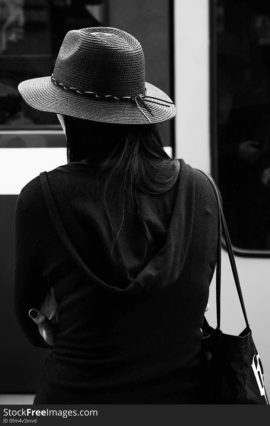 Greyscale Photo of a Woman Wearing a Hat