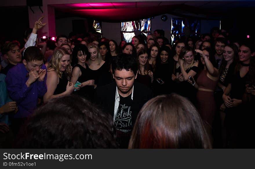 Crowd of young men and women dancing at nightclub. Crowd of young men and women dancing at nightclub.