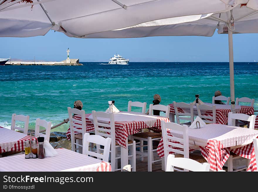 Seaside dining by the Mykonos harbour. Seaside dining by the Mykonos harbour.