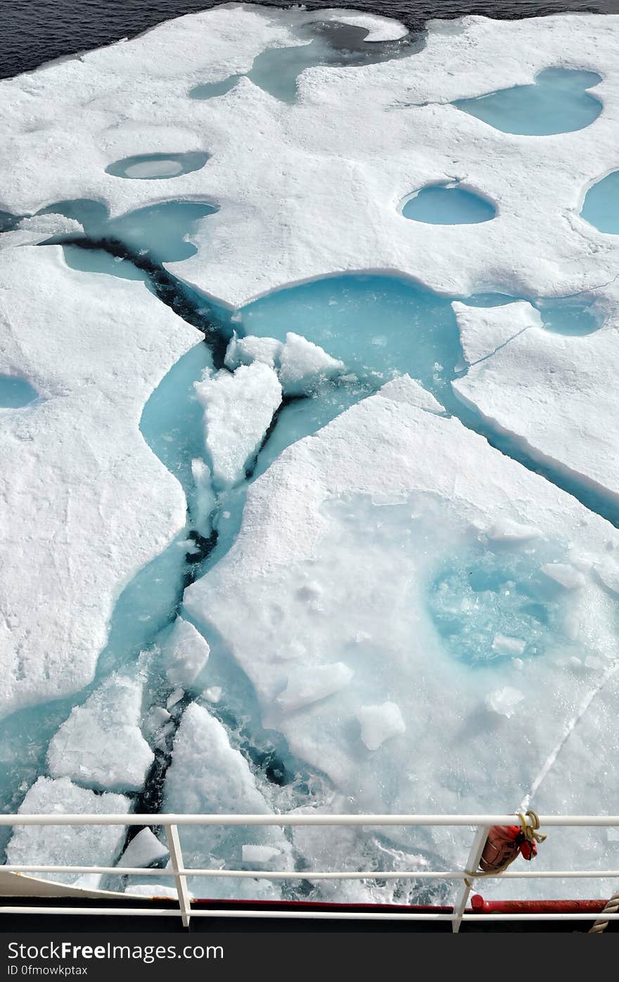 ARCTIC OCEAN - A multi-year ice floe slides down the starboard side of the Coast Guard Cutter Healy Aug. 11, 2009, as the ship heads north into even thicker ice. &#x22;You can tell that this is a multi-year ice floe by the light blue melt ponds that have formed on top of the floe, &#x22; said Pablo Clemente-Colón, chief scientist at the U. S. National Ice Center. Photo Credit: Patrick Kelley, U. S. Coast Guard