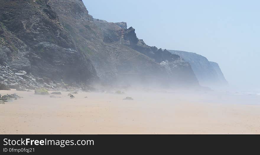 Steam over the heated wet sand in low tide. Steam over the heated wet sand in low tide.