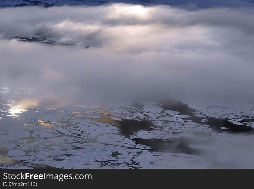 The sun shines through the clouds over the Arctic Ocean Aug. 20, 2009. Photo Credit: Patrick Kelley, U.S. Coast Guard. The sun shines through the clouds over the Arctic Ocean Aug. 20, 2009. Photo Credit: Patrick Kelley, U.S. Coast Guard