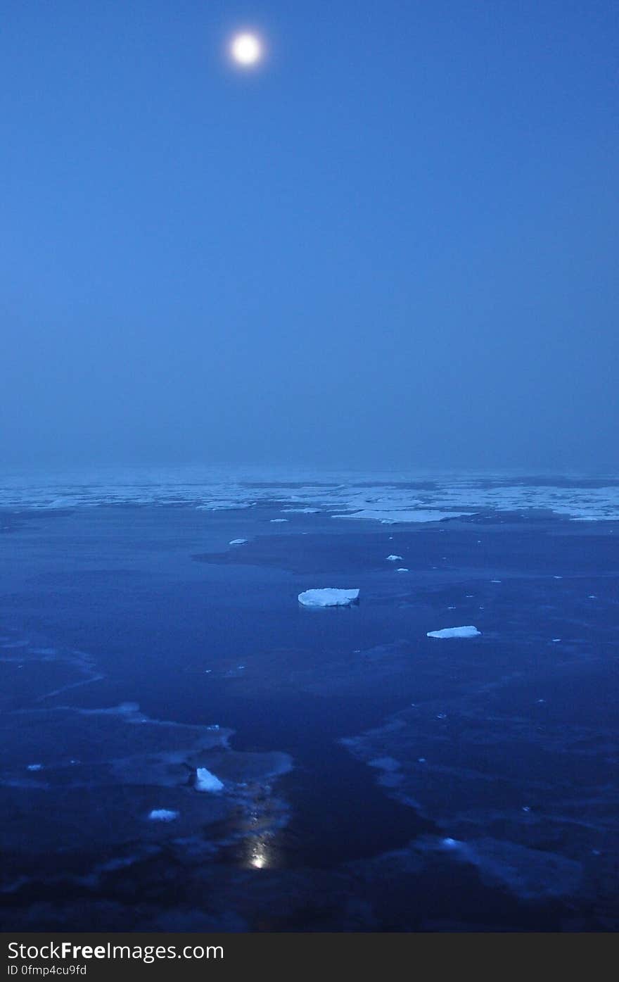 The moon hovers above the Arctic Ocean horizon Sept. 10, 2009. Photo Credit: Patrick Kelley, U.S. Coast Guard. The moon hovers above the Arctic Ocean horizon Sept. 10, 2009. Photo Credit: Patrick Kelley, U.S. Coast Guard