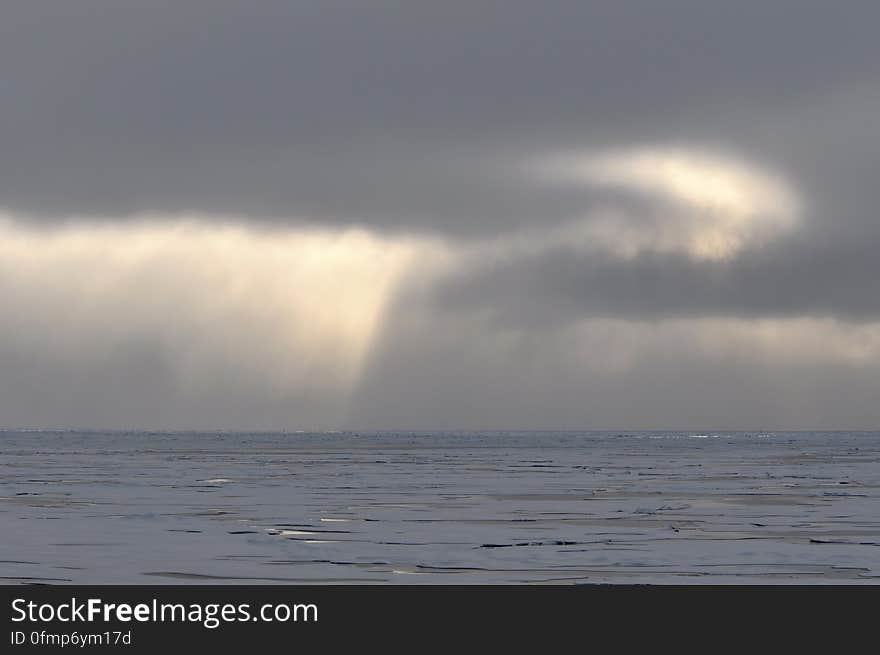 The sun shines through the clouds over the Arctic Ocean Aug. 17, 2009. Photo Credit: Patrick Kelley, U.S. Coast Guard. The sun shines through the clouds over the Arctic Ocean Aug. 17, 2009. Photo Credit: Patrick Kelley, U.S. Coast Guard