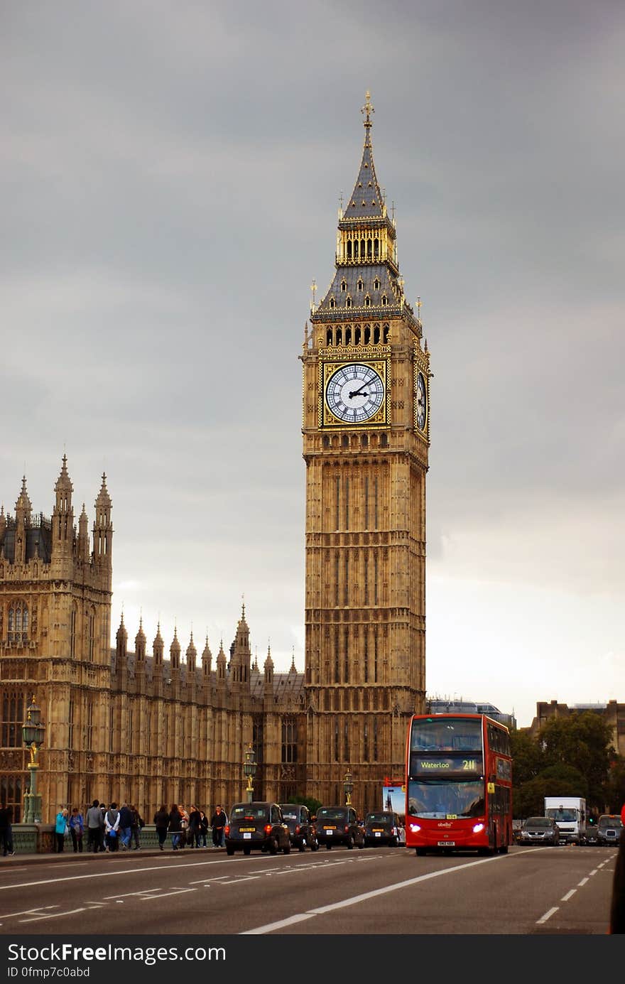 Big Ben Tower Near City Road With Bus and Cars Traveling Under Gray White Clouds