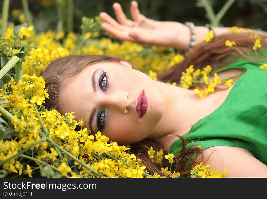 Close-up Portrait of Young Woman With Yellow Flowers