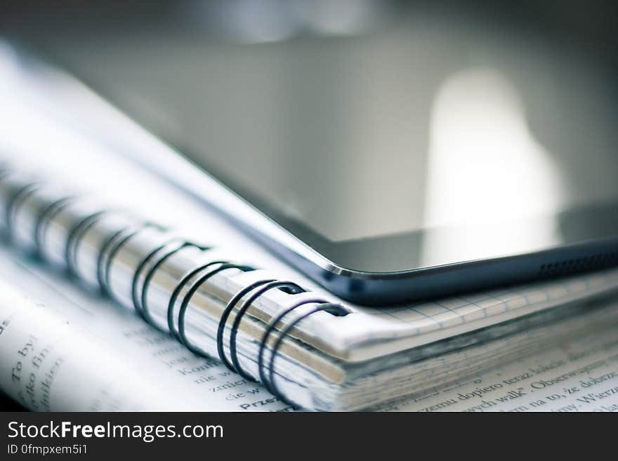 A close up of a smartphone on a notebook. A close up of a smartphone on a notebook.