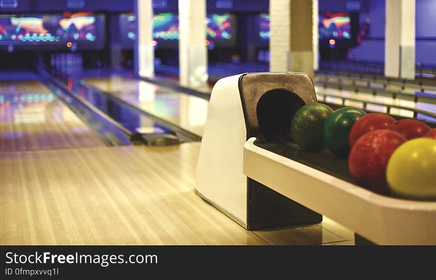 Colorful balls in an empty bowling alley. Colorful balls in an empty bowling alley.