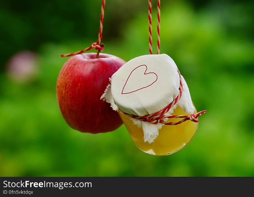 Red Apple Fruit Beside Clear Glass Jar