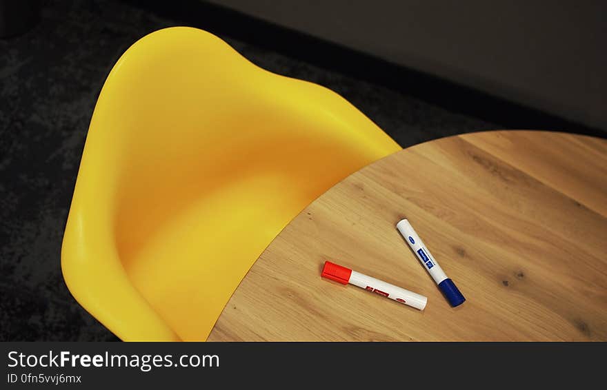 Blue Marker on Brown Wooden Table