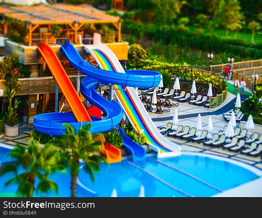 A swimming pool with water slides in an amusement park.