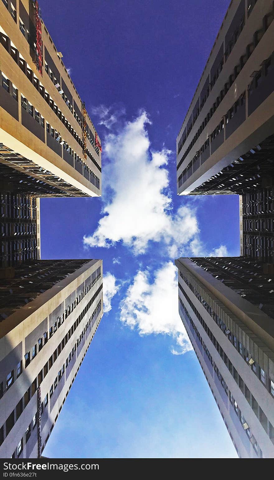 Low Angle View of Skyscraper Against Cloudy Sky