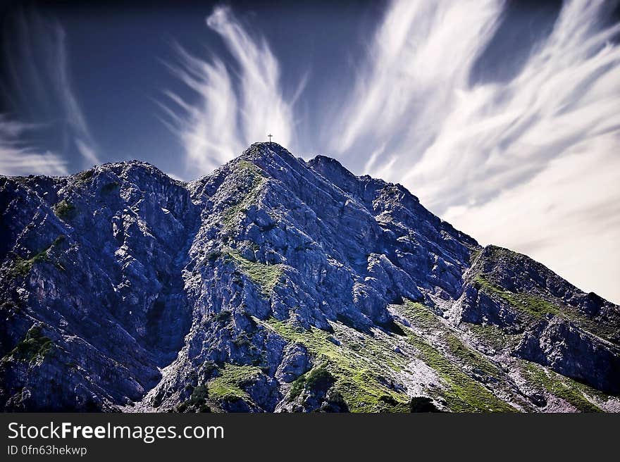 Rocky mountain landscape against blue skies with white clouds. Rocky mountain landscape against blue skies with white clouds.