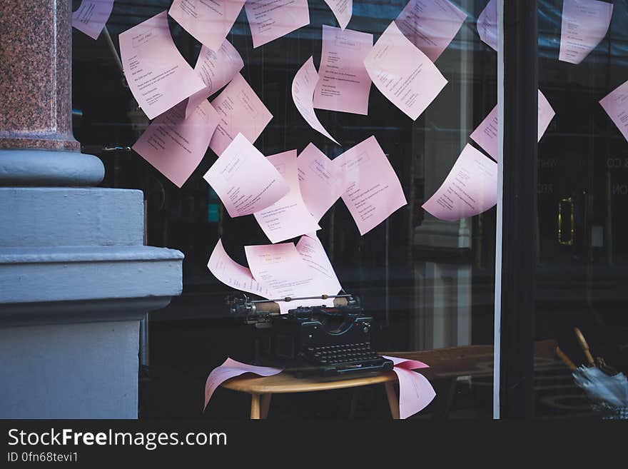 A display with typewriter and papers flying out of it.