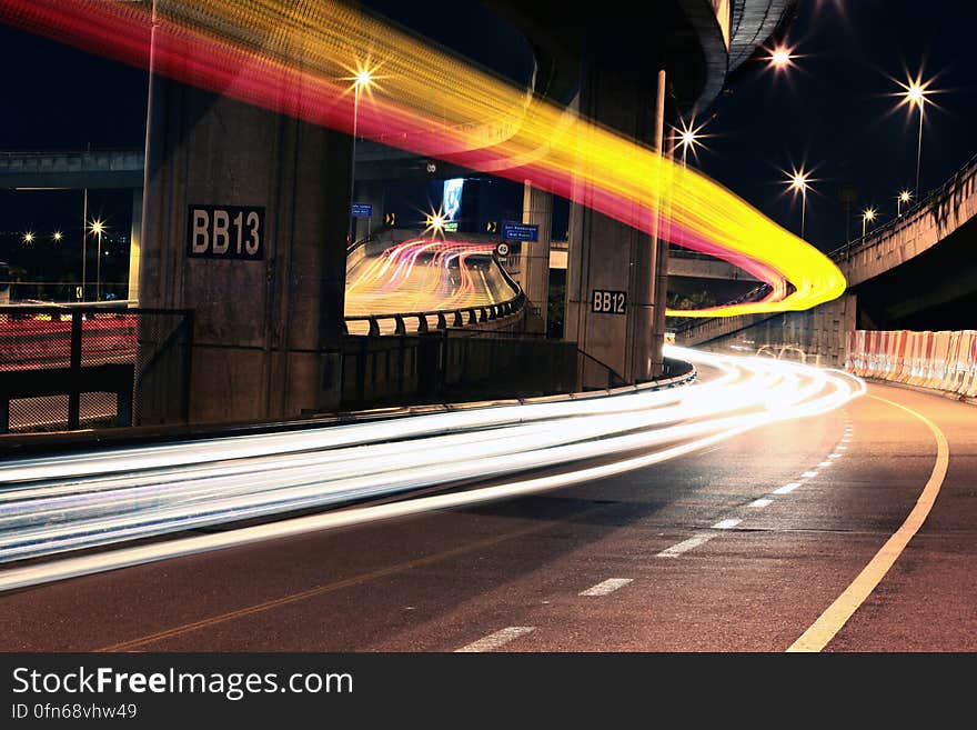 Streaks of lights from headlights on bridge at night. Streaks of lights from headlights on bridge at night.