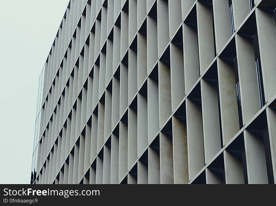 Modern high rise building with concrete frame around each window producing an abstract repetitive honeycomb structure. Modern high rise building with concrete frame around each window producing an abstract repetitive honeycomb structure.