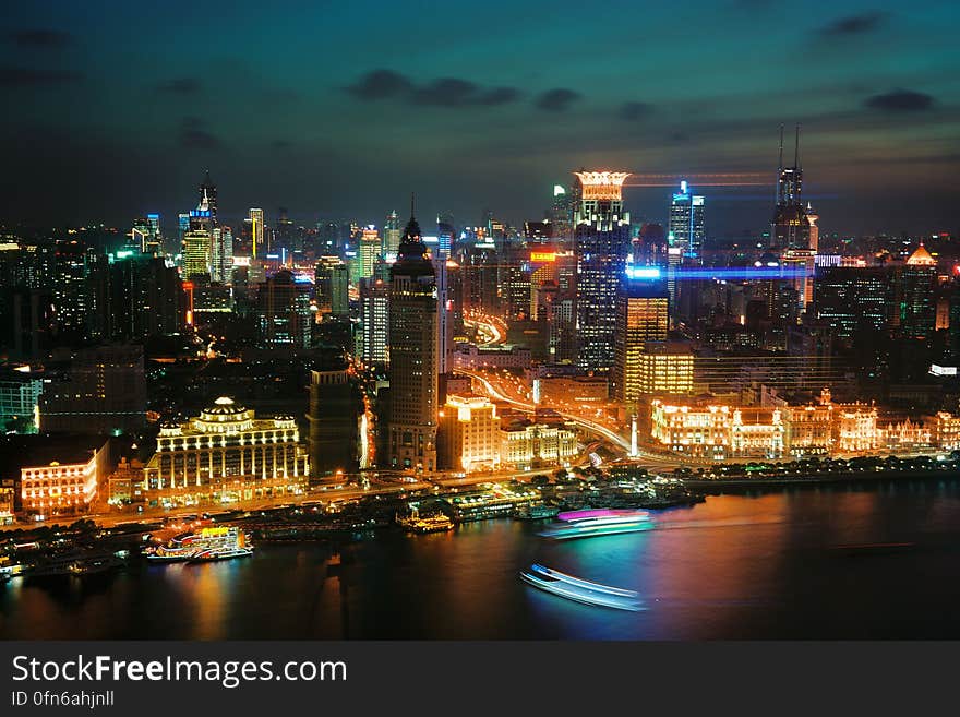 The city of Shanghai at night as seen from the Huagnpu river.