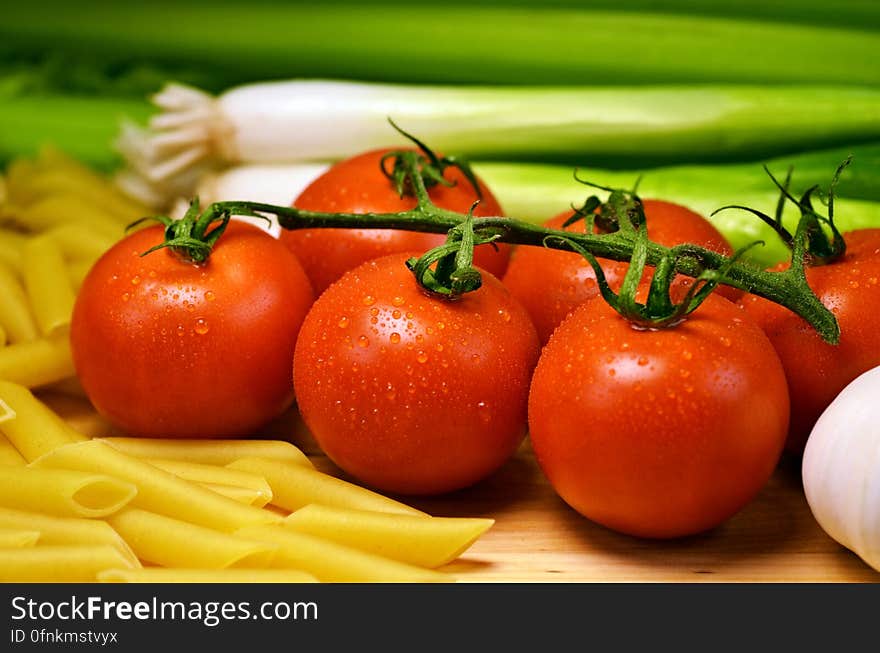 Close Up Photo of Red Tomatoes Near Pasta