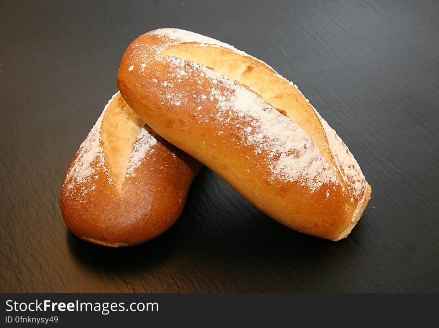 Close up of bakery rolls on wooden tabletop.