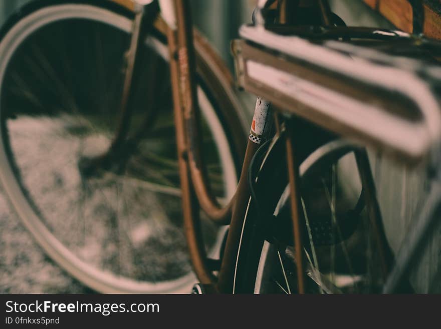 Close up of bike frame and tire on streets.