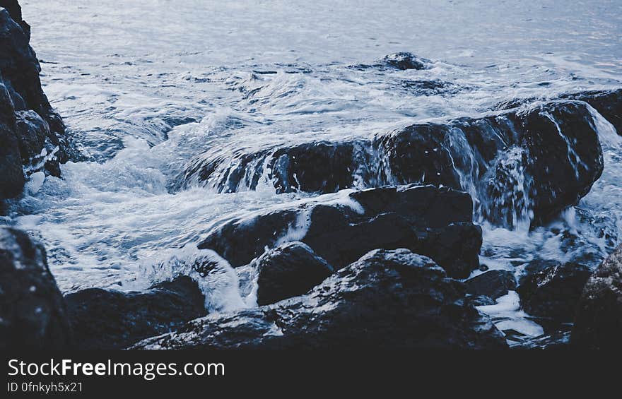 Waves washing over rocky shores along waterfront. Waves washing over rocky shores along waterfront.