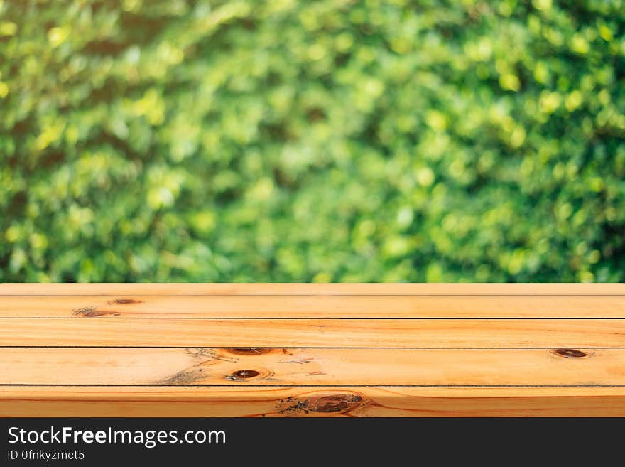 Rustic wooden boards against green bokeh background. Rustic wooden boards against green bokeh background.