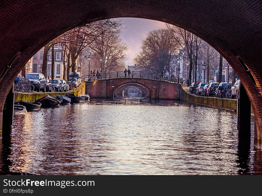 Under arched canal bridge in Amsterdam, Netherlands. Under arched canal bridge in Amsterdam, Netherlands.