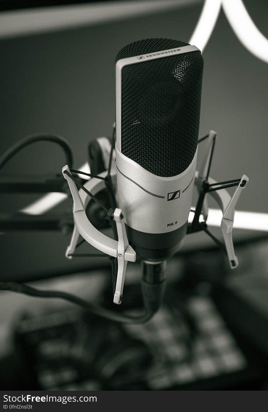 Close up of recording microphone on metal stand in black and white. Close up of recording microphone on metal stand in black and white.