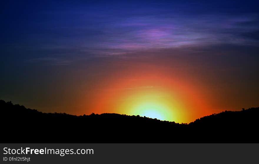 Silhouette of hillside at sunset with colorful skies. Silhouette of hillside at sunset with colorful skies.