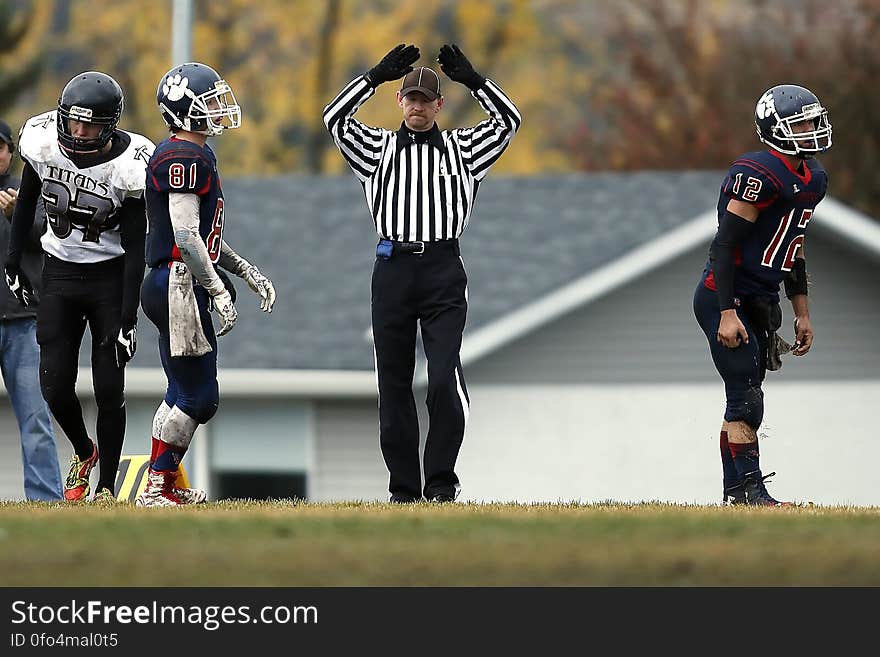 Referee Between 3 Football Player