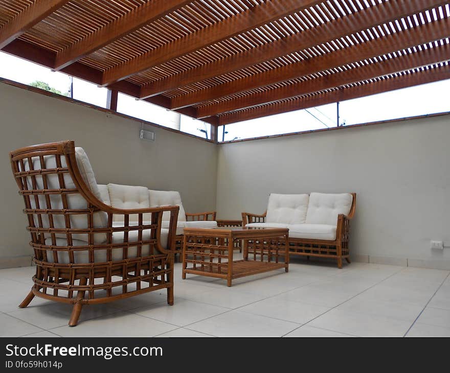 A patio with rattan furniture and cover. A patio with rattan furniture and cover.