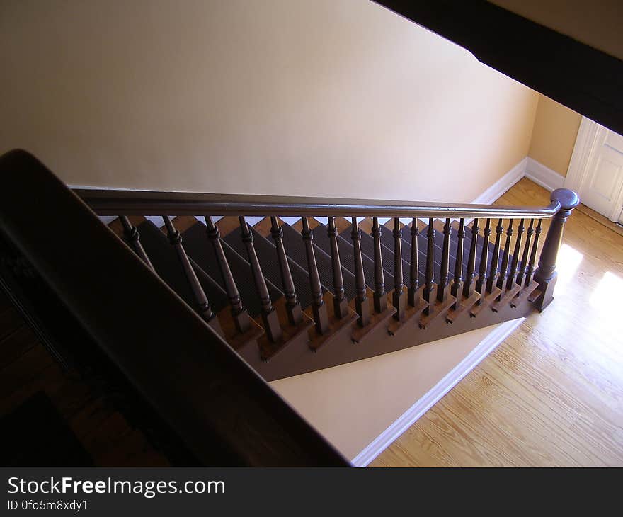 A staircase with railing in a house. A staircase with railing in a house.