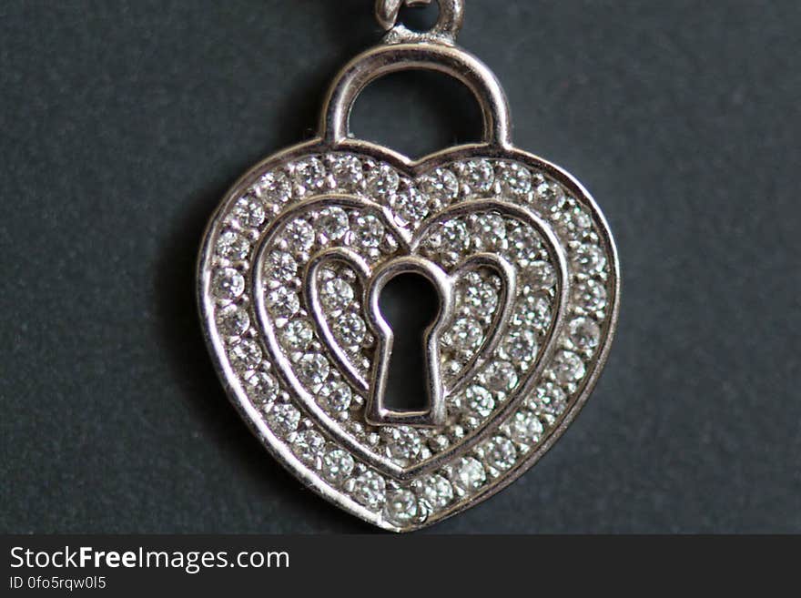 A heart shaped necklace with a keyhole. A heart shaped necklace with a keyhole.