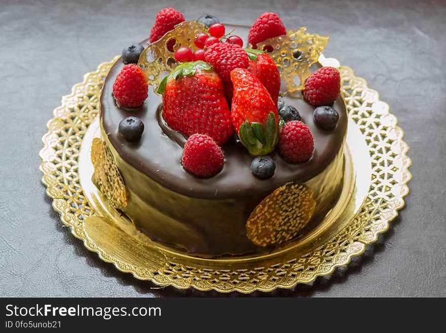 A chocolate cake with blueberries, strawberries and raspberries and spun sugar. A chocolate cake with blueberries, strawberries and raspberries and spun sugar.