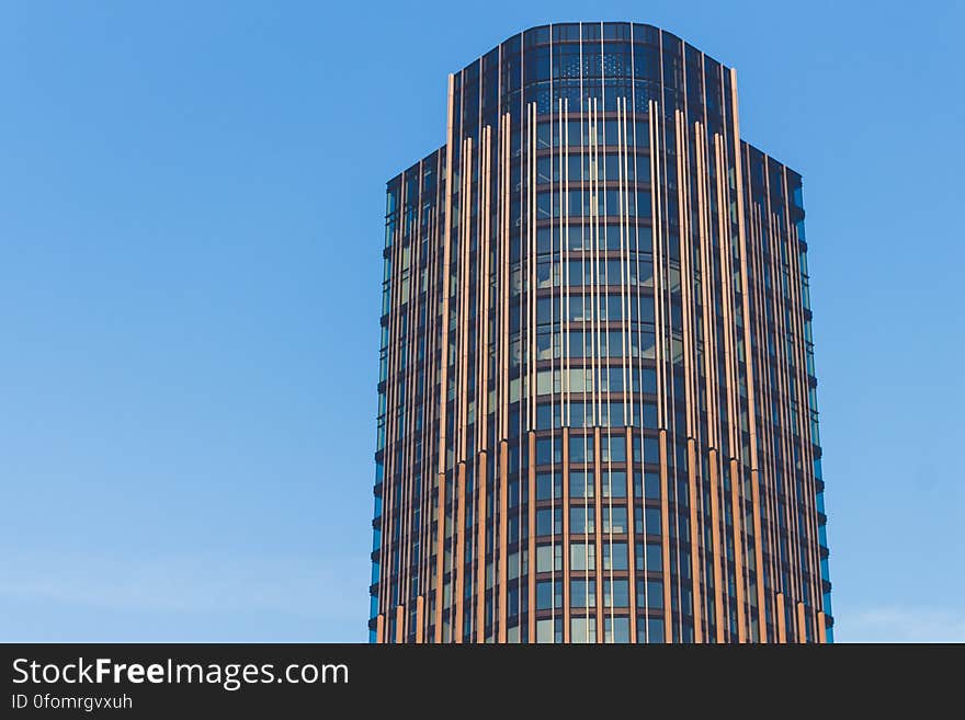 A contemporary high rise building against the blue skies.