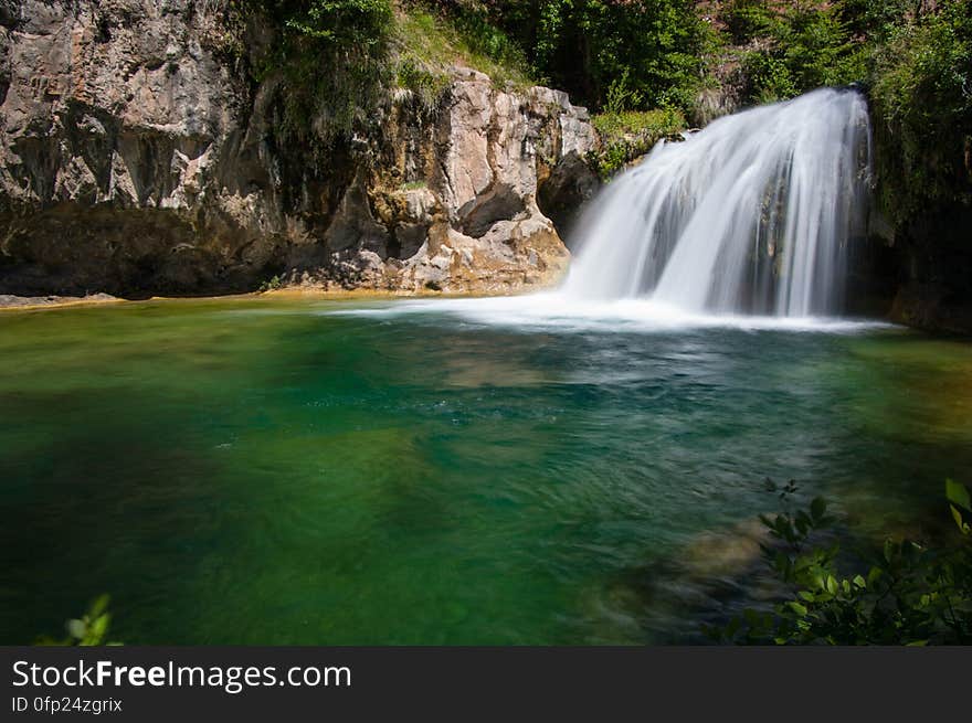 This large, natural waterfall on Fossil Creek is the destination of an easy, one mile hike on Waterfall Trail. A large, deep pool at the base of the fall is a popular swimming hole. Fossil Creek produces 20,000 gallons of water a minute from a series of springs at the bottom of a 1,600 foot deep canyon. This permanent water source has created a stunningly beautiful, green riparian zone rich with flora and fauna at the bottom of this arid canyon in Arizona&#x27;s high desert. Travertine deposits encase whatever happens to fall into the streambed, forming the fossils for which the area is named. These deposits create deep pools along the length of the creek, providing opportunities to find more secluded swimming holes than the popular pool at the waterfall. Fossil Creek is one of two &quot;Wild and Scenic&quot; rivers in Arizona. This designation was achieved when the Irving power plant was decommissioned, and removal of flume and dam on the creek allowed the creek to flow free. Increasing popularity has led to the Coconino and Tonto National Forests to implement a parking permit reservation system in 2016. Reserved parking permits allow visitors to have a parking spot available in their chosen parking lot. Many visitors drive two or three hours to get to the creek. The final descent to the creek at the bottom of a canyon is on an extremely rough, rocky jeep road. In prior years, the area would often be closed to entry when it reached capacity, and potential visitors would be turned away after the long, difficult drive. Photo by Deborah Lee Soltesz, May 12, 2016. For trail and recreation information, see Fossil Creek, Fossil Springs Wilderness, and the Coconino National Forest. This large, natural waterfall on Fossil Creek is the destination of an easy, one mile hike on Waterfall Trail. A large, deep pool at the base of the fall is a popular swimming hole. Fossil Creek produces 20,000 gallons of water a minute from a series of springs at the bottom of a 1,600 foot deep canyon. This permanent water source has created a stunningly beautiful, green riparian zone rich with flora and fauna at the bottom of this arid canyon in Arizona&#x27;s high desert. Travertine deposits encase whatever happens to fall into the streambed, forming the fossils for which the area is named. These deposits create deep pools along the length of the creek, providing opportunities to find more secluded swimming holes than the popular pool at the waterfall. Fossil Creek is one of two &quot;Wild and Scenic&quot; rivers in Arizona. This designation was achieved when the Irving power plant was decommissioned, and removal of flume and dam on the creek allowed the creek to flow free. Increasing popularity has led to the Coconino and Tonto National Forests to implement a parking permit reservation system in 2016. Reserved parking permits allow visitors to have a parking spot available in their chosen parking lot. Many visitors drive two or three hours to get to the creek. The final descent to the creek at the bottom of a canyon is on an extremely rough, rocky jeep road. In prior years, the area would often be closed to entry when it reached capacity, and potential visitors would be turned away after the long, difficult drive. Photo by Deborah Lee Soltesz, May 12, 2016. For trail and recreation information, see Fossil Creek, Fossil Springs Wilderness, and the Coconino National Forest.