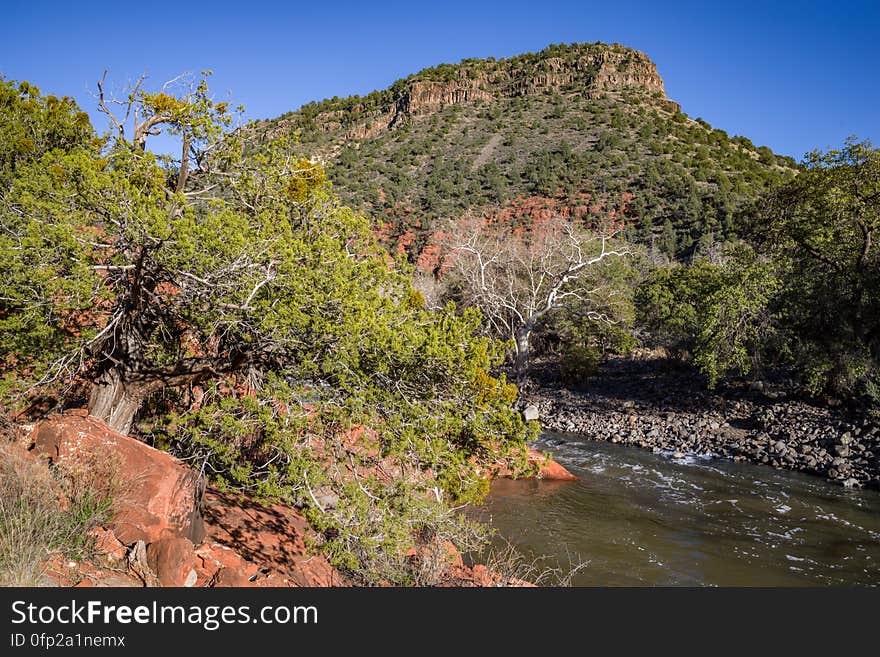 Snowmelt from a series winter storms in late January 2017 followed by rain and warm weather in February had dry creekbeds running and many of Arizona&#x27;s reservoirs filled and overflowing. Dry Beaver Creek in Woods Canyon was no exception. Woods Canyon Trail is level and unshaded as it follows a jeep road into the wide canyon mouth for 1.25 miles. The road ends and the trail continues, climbing gradually. There are views of the vegetation-covered slopes of mesas on either side. The trail enters Munds Mountain Wilderness continuing its easy climb. The trail approaches and then follows Dry Beaver Creek. At the confluence with Rattlesnake Canyon, the trail emerges onto a picturesque expanse of redrock studded with huge, gray boulders. Further down some nice redrock views as the trail climbs on a moderate grade out of the creekbed. Photo by Deborah Lee Soltesz, February 15, 2017. Credit: Coconino National Forest, U.S. Forest Service. Learn more about Woods Canyon Trail No. 93 on the Coconino National Forest.