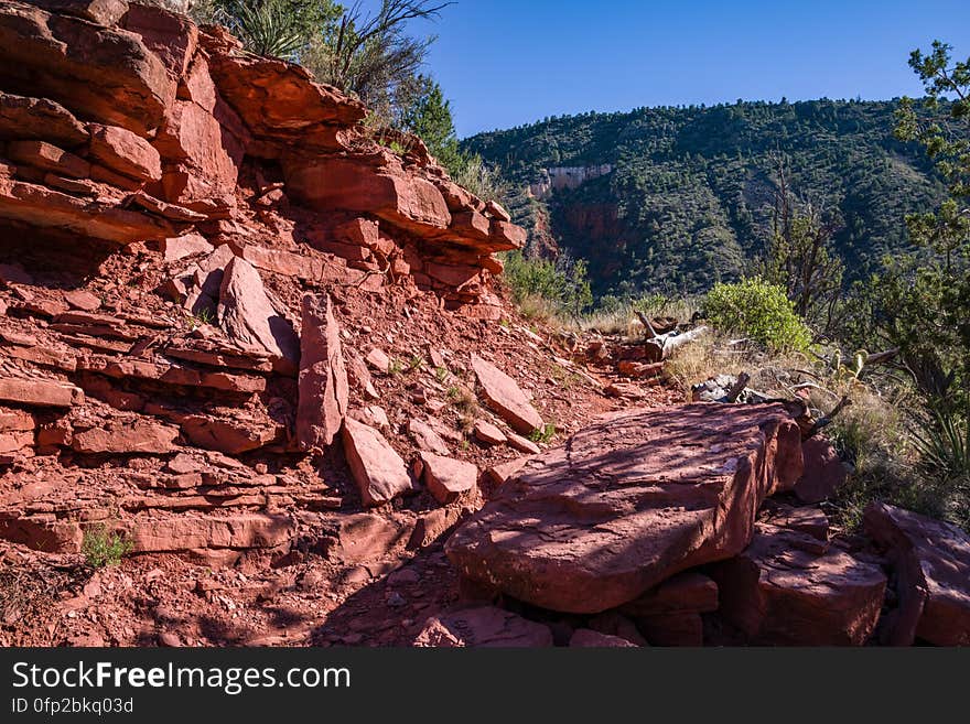 Snowmelt from a series winter storms in late January 2017 followed by rain and warm weather in February had dry creekbeds running and many of Arizona&#x27;s reservoirs filled and overflowing. Dry Beaver Creek in Woods Canyon was no exception. Woods Canyon Trail is level and unshaded as it follows a jeep road into the wide canyon mouth for 1.25 miles. The road ends and the trail continues, climbing gradually. There are views of the vegetation-covered slopes of mesas on either side. The trail enters Munds Mountain Wilderness continuing its easy climb. The trail approaches and then follows Dry Beaver Creek. At the confluence with Rattlesnake Canyon, the trail emerges onto a picturesque expanse of redrock studded with huge, gray boulders. Further down some nice redrock views as the trail climbs on a moderate grade out of the creekbed. Photo by Deborah Lee Soltesz, February 15, 2017. Credit: Coconino National Forest, U.S. Forest Service. Learn more about Woods Canyon Trail No. 93 on the Coconino National Forest.