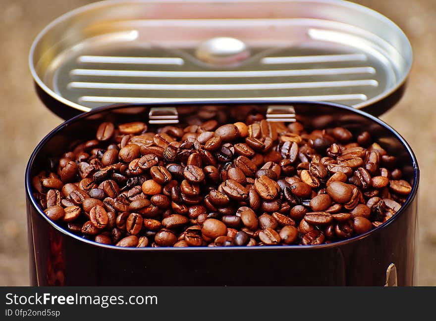 A tin of roasted coffee beans.