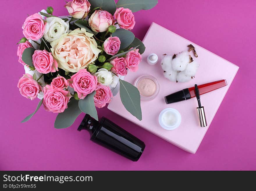 A bouquet of flowers and make-up equipment with cotton buds. A bouquet of flowers and make-up equipment with cotton buds.