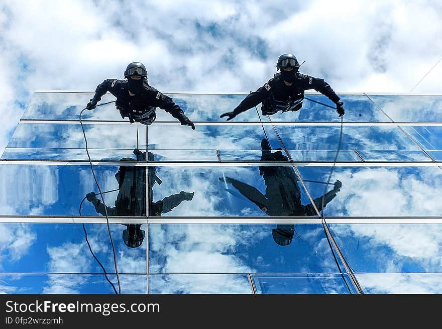 Gendarmes climbing down a building using ropes. Gendarmes climbing down a building using ropes.