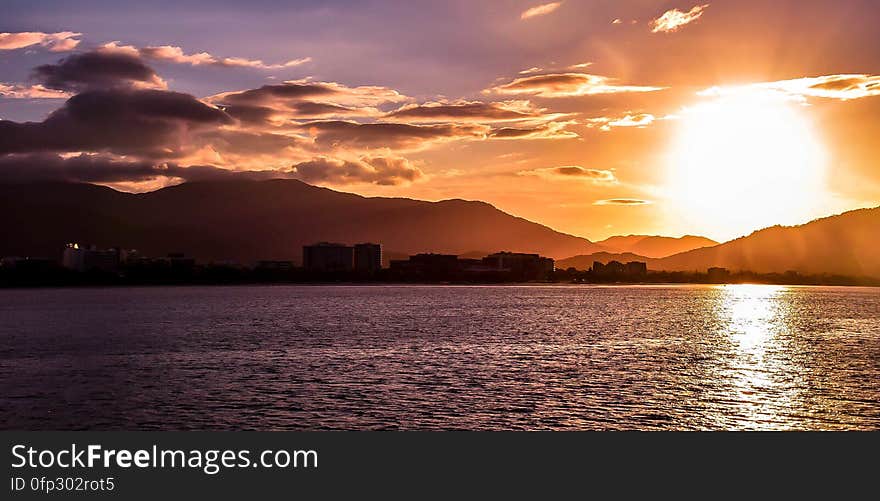 A sunset over a city seen from the sea. A sunset over a city seen from the sea.