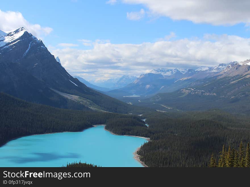 A valley with a blue lake in a valley between the mountains. A valley with a blue lake in a valley between the mountains.