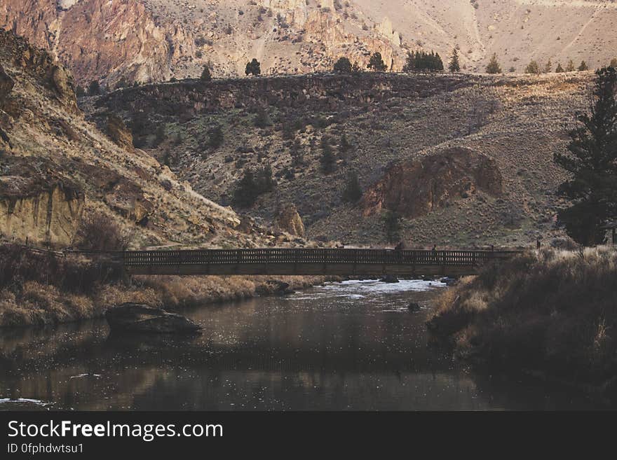 A bridge crossing a canyon with a river on the bottom. A bridge crossing a canyon with a river on the bottom.