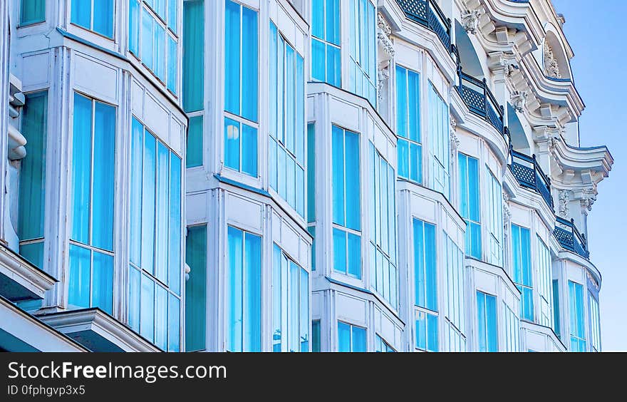 Row of modern town house buildings with blue windows, diminishing perspective.