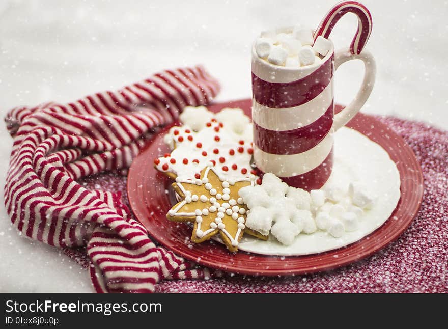 A cup of hot chocolate with gingerbread cookies on a plate. A cup of hot chocolate with gingerbread cookies on a plate.