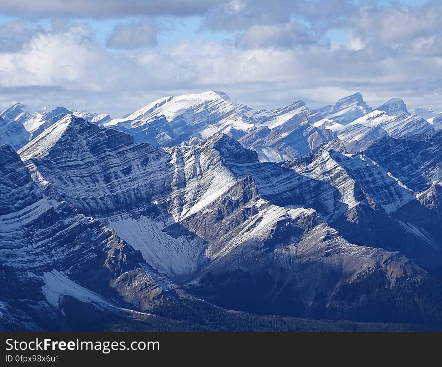 A mountain range with snow-capped peaks. A mountain range with snow-capped peaks.