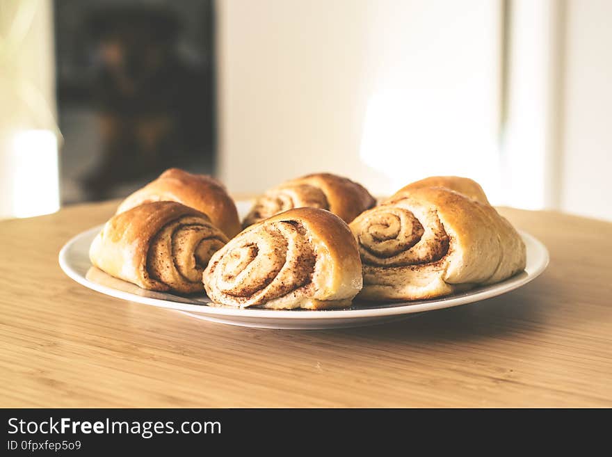 A close up of homemade cinnamon buns on a plate.