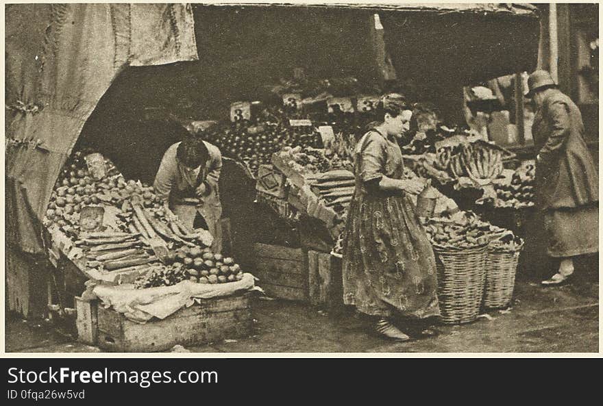 London, 1920s Photogravure by Donald Macleish from Wonderful London by St John Adcock, 1927. From the section entitled Some of the sights and sounds that liven London streets: A greengrocer in the Commercial Road. In the East End and all over the poorer parts of London a strange kind of establishment, half shop and half booth, is common.